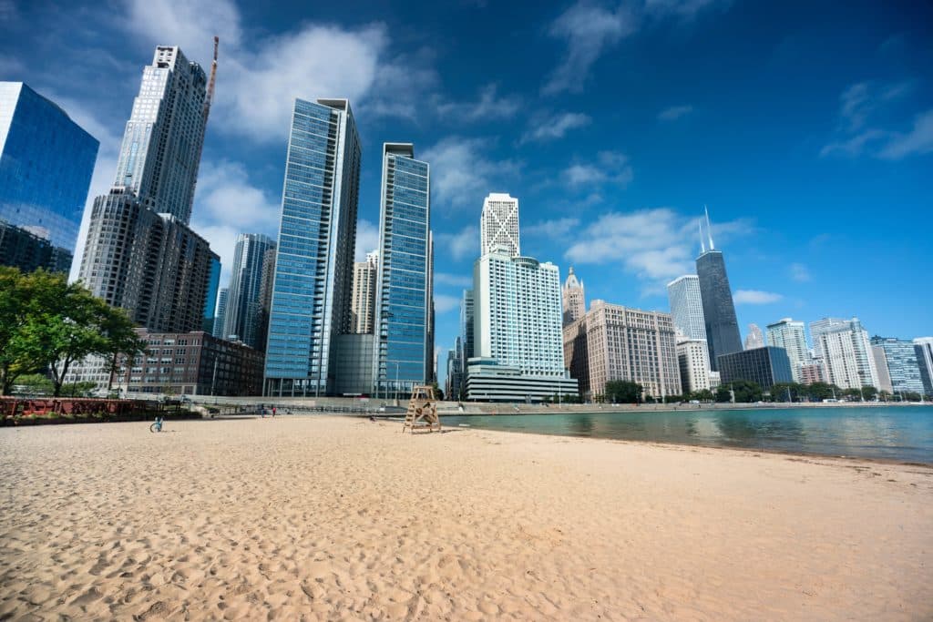 Chicago cityscape across the sand of Ohio Street Beach on Lake Michigan and Lake Shore Drive in Illinois USA