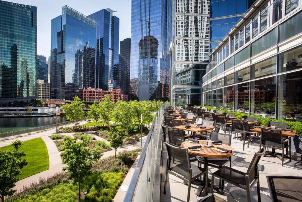 gibsons rooftop overlooking green grass and the chicago river and the city skyline