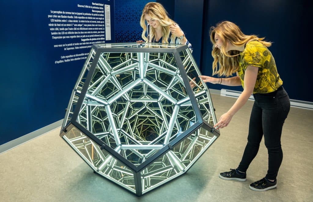 Image showing two people looking at an optical illusion inside a new exhibit at the Museum of Illusions
