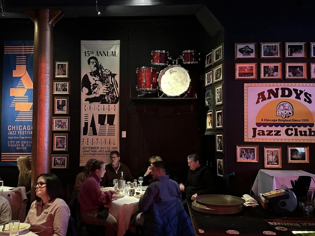 pictures of famous jazz musicians with people dining underneath them at Andy's Jazz club in chicago