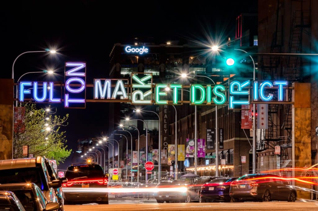 Fulton Market District gateway at night with long exposure light trails. Main street in West Loop, Chicago on May 13, 2019.