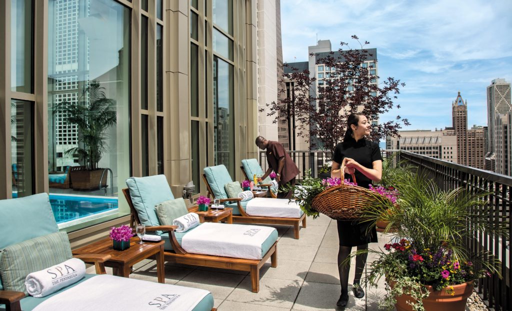 Image showing staff at the Peninsula Hotel in Chicago tending to the rooftop terrace and pool area