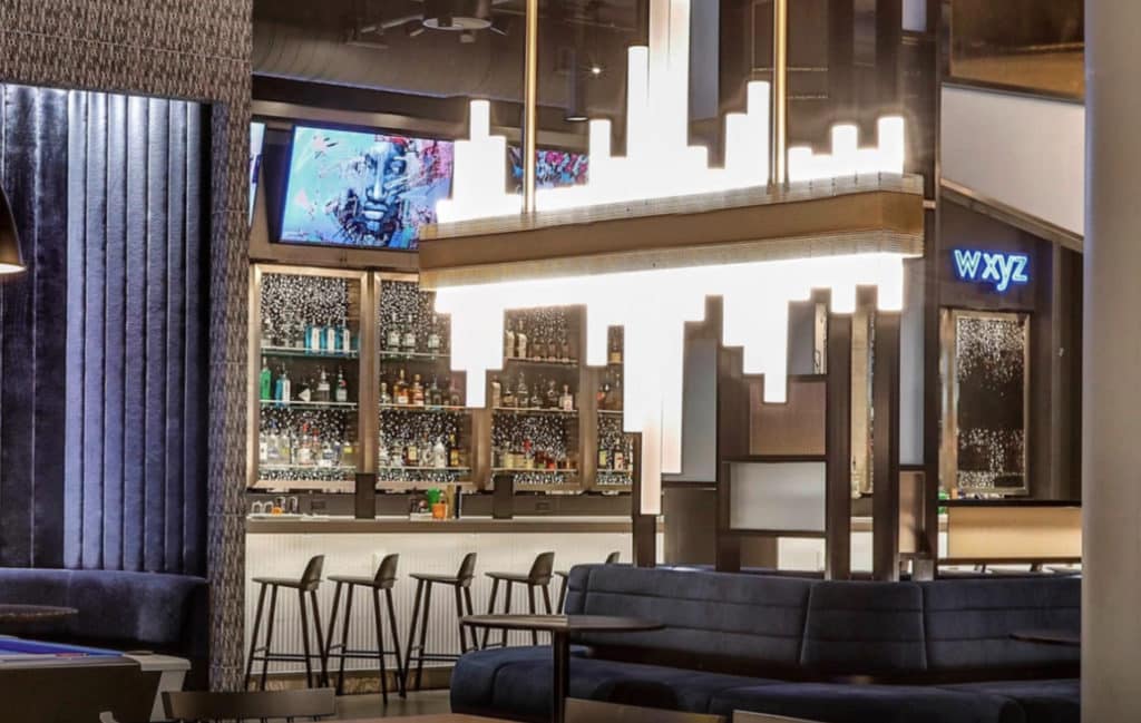  W XYZ bar at Aloft Chicago Mag Mile with stools and alcohol bottles on the selves behind 