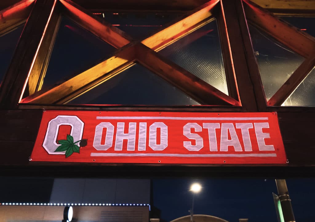 large red ohio state banner hanging on wooden beams at Old Crow Smokehouse