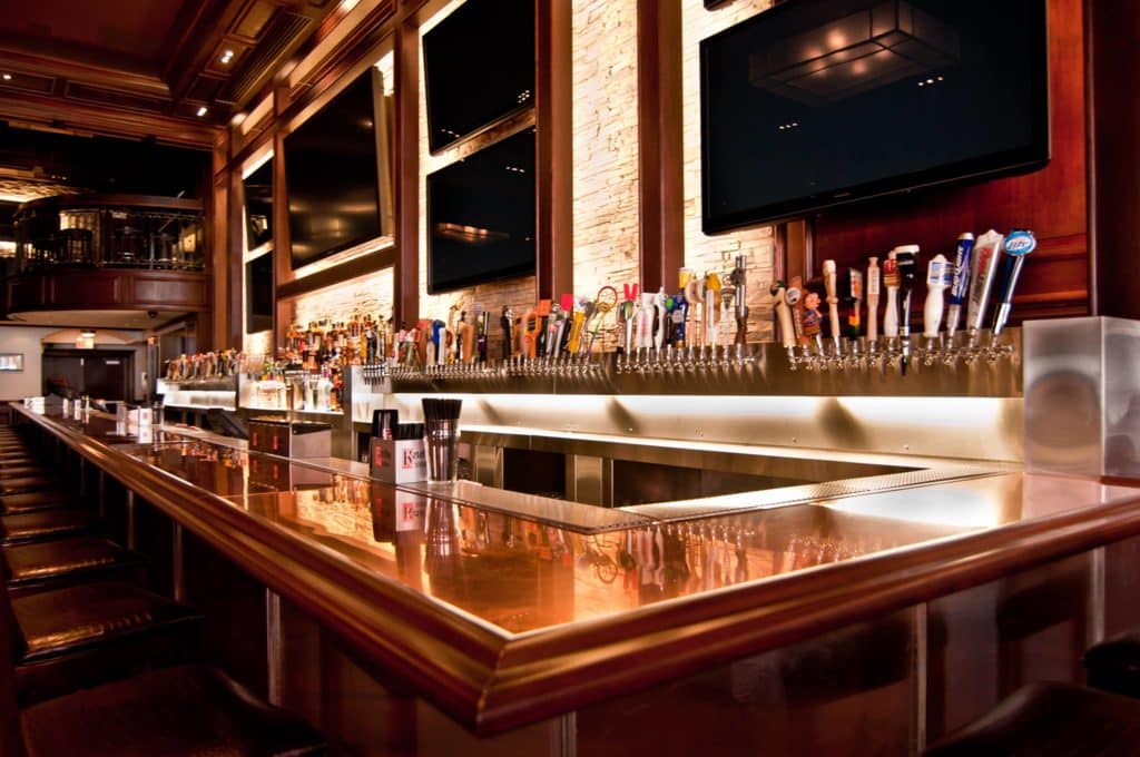 over 30 different beer taps by the bars with stools on the edge at old town pour house in Chicago