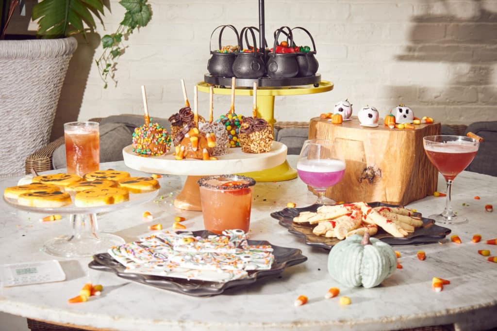 a selection of halloween theme sweet with cake pop and a selection of spooky drinks on top of a table at summer house in lincoln park