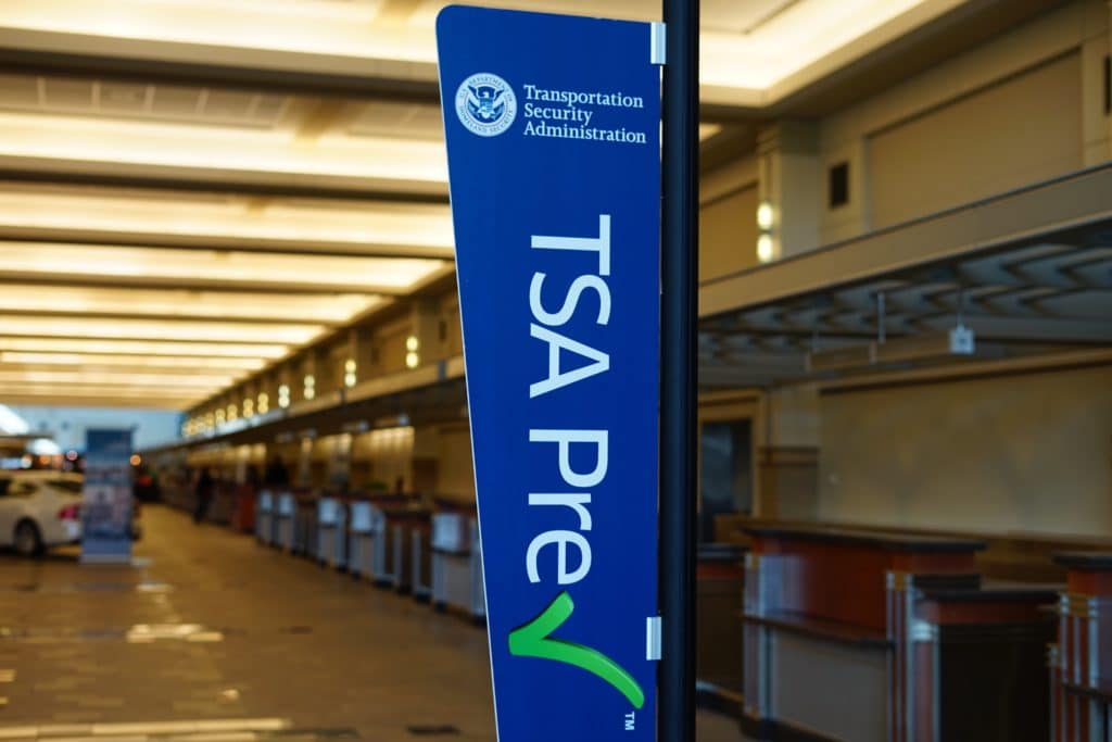 sign encouraging passengers to register for the time-saving TSA Prec Check program in the United Airlines (UA) terminal at the Chicago O'Hare International Airport (ORD).